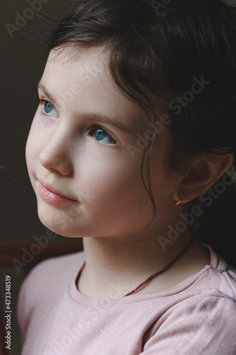 Cute blue eyed girl looking away photo