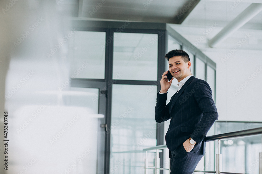 Young business man talking on phone in the office Young business man talking on phone in the office