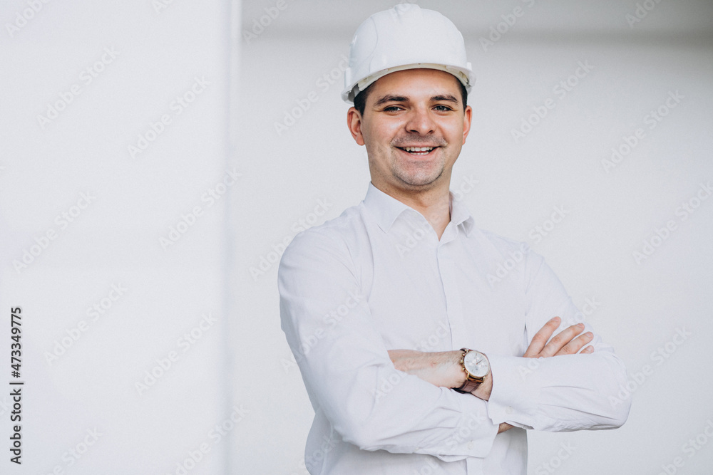 Handsome business man engineer in hard hat in a building Handsome business man engineer in hard hat in a building