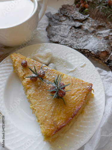  Cup of latte coffee and piece of apple pie on a decorated holiday table