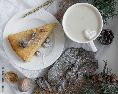 Coffee and cookies. Still life with slice of apple pie, cup of latte coffee and pine bark sprinkled with powdered sugar