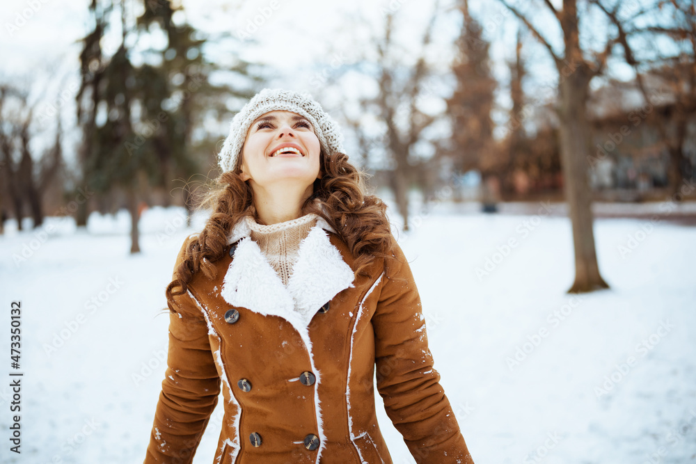 happy stylish female outside in city park in winter happy stylish female outside in city park in winter