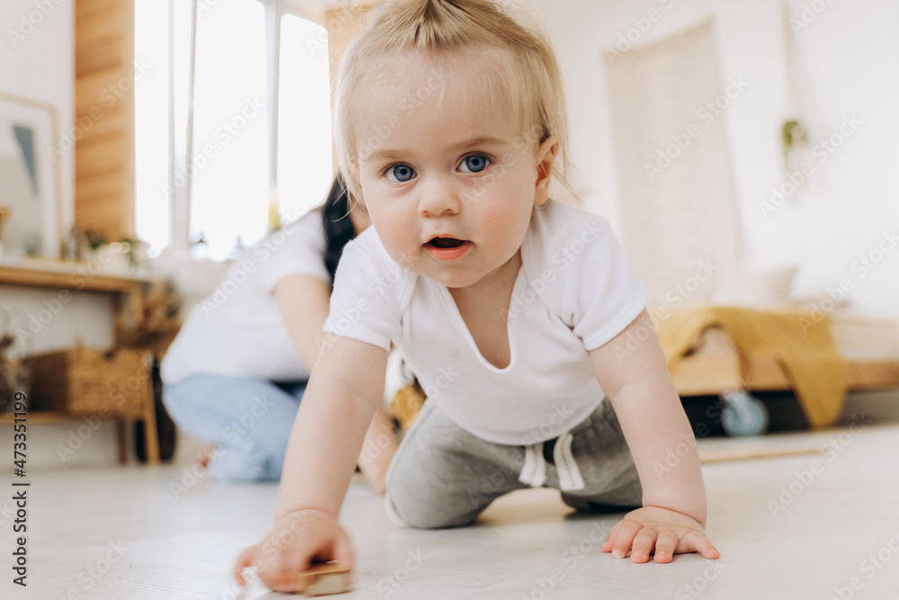 Communication between mother and child. Love and kindness in the family. The kid plays with wooden eco-friendly toys. Communication between mother and child. Love and kindness in the family. The kid plays with wooden eco-friendly toys.