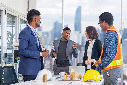African American manager is discussing to his colleagues in the executive meeting for real estate development and landscape architecture for global business strategy and diversity workplace concept photo