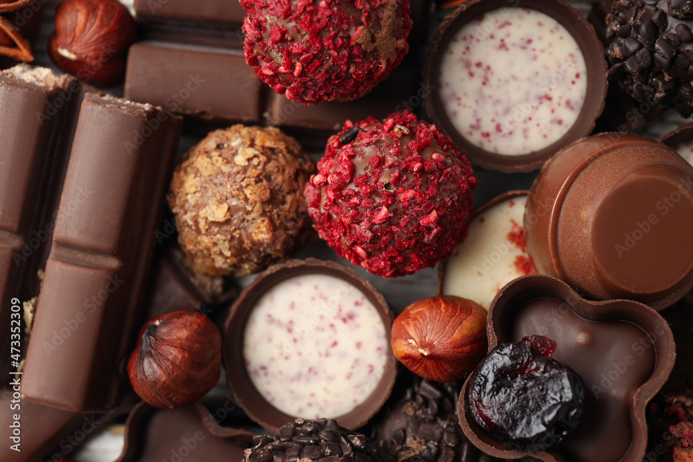 Tasty chocolate candies all over background, close up Tasty chocolate candies all over background, close up