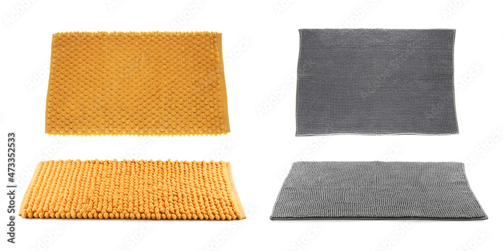 Fototapeta premium Set with soft bath mats on white background
