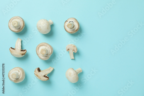 Flat lay composition with champignons on blue background