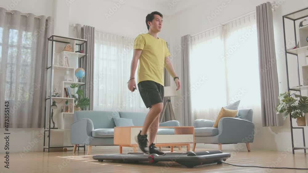 Asian Man Training On Walking Treadmill At Home
Asian Man Training On Walking Treadmill At Home