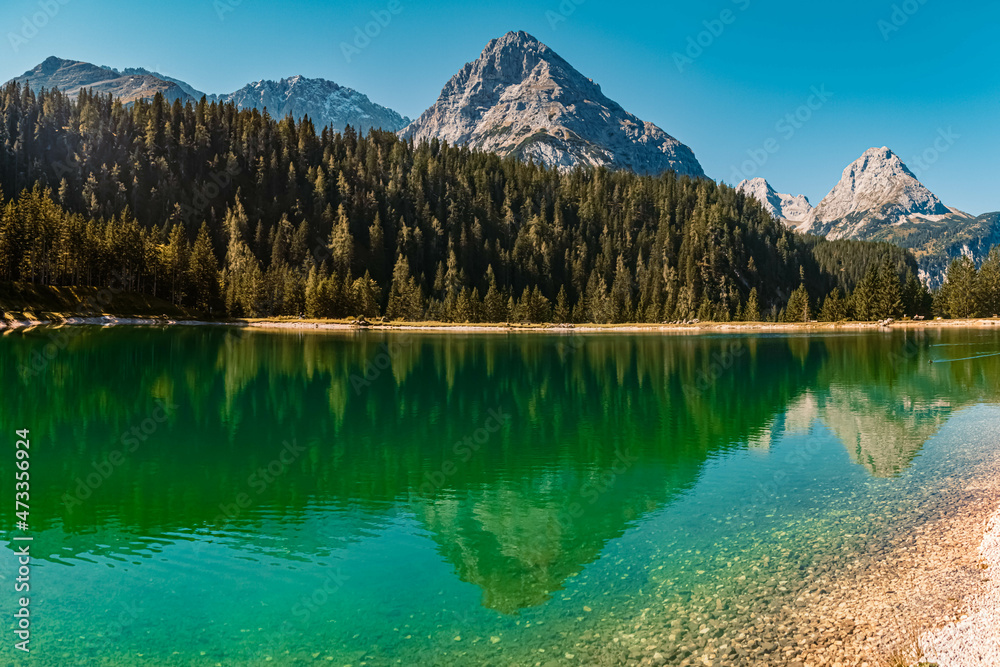 High resolution panorama of an alpine summer view with reflections in a lake and mountains in the background at the Ehrwalder Alm near Ehrwald, Tyrol, Austria