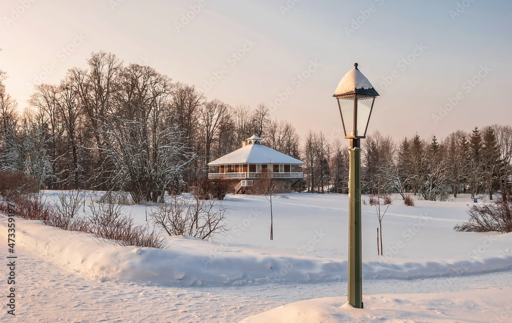 Evening winter landscape with a lantern and a beautiful house in the forest Evening winter landscape with a lantern and a beautiful house in the forest