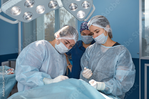 Concentrated Surgical team operating a patient in an operation theater. Well-trained anesthesiologist with years of training with complex machines follows the patient throughout the surgery