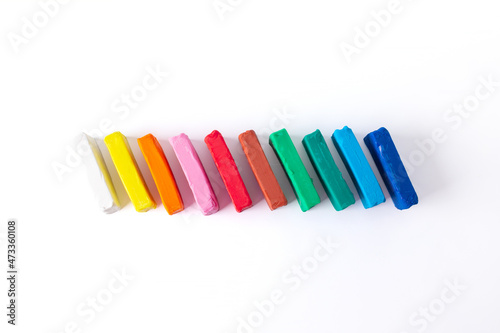 Сhild colorful plasticine on white background top view