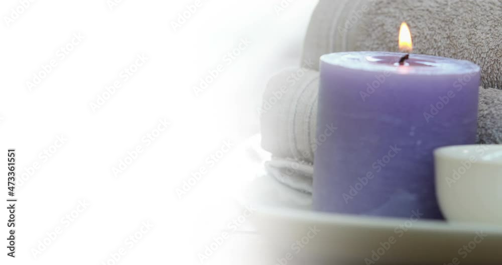 Animation of white background over towels and candle Animation of white background over towels and candle