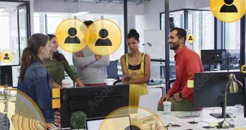 Animation of media icons over happy diverse busines people discussing in office photo