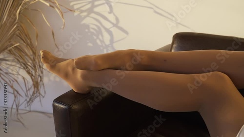 Woman's feet in pantyhose close-up indoors