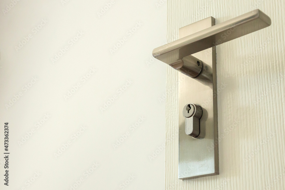 Modern door handle with keyhole on white door