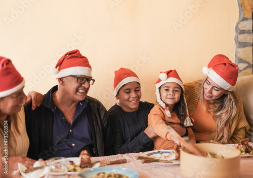 Lovely latin family celebrating christmas together with dinner at home on patio