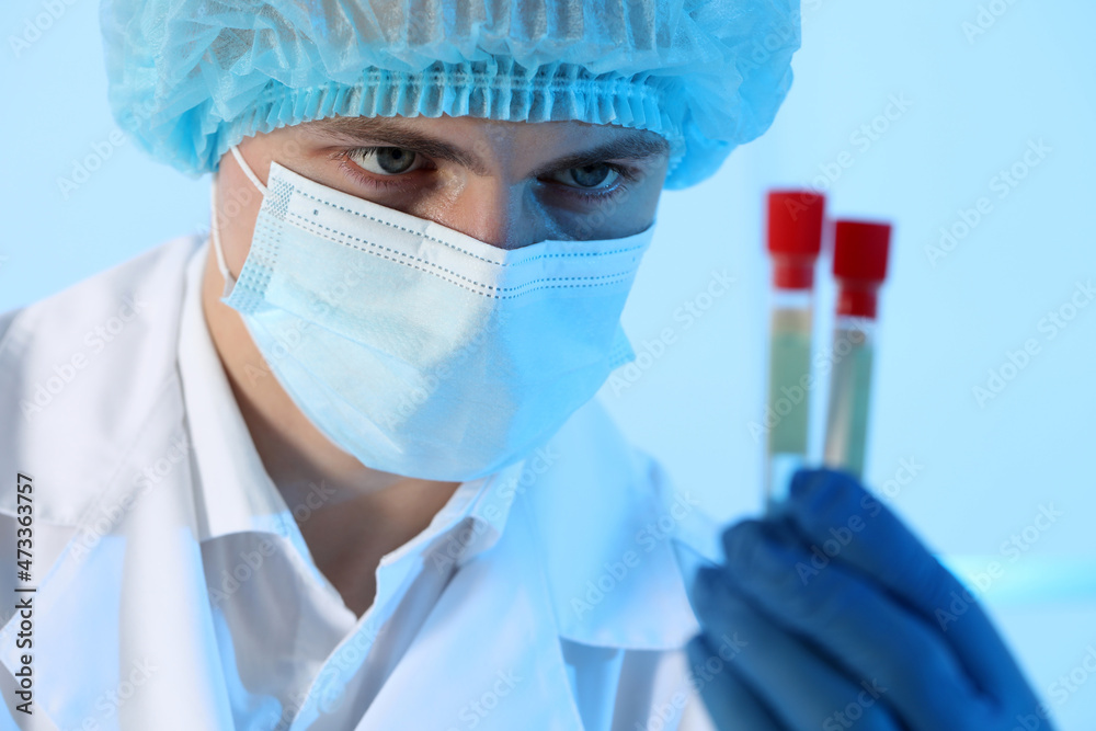 Scientist working with samples on light blue background, closeup. Medical research