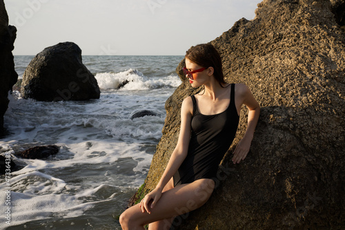pretty woman in swimsuit island rocks posing summer