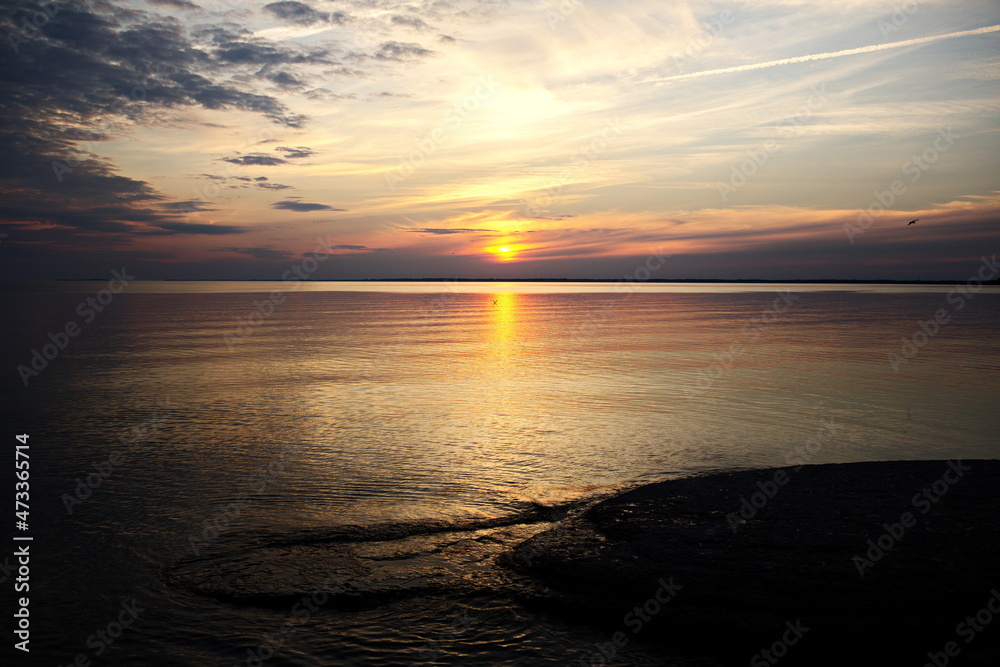 The sun setting over Sandbanks Provincial Park in Prince Edward County. The beaches and dunes attract tourists to this spot every year in Ontario, Canada.