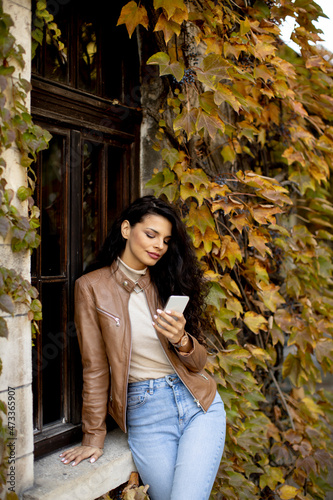 Young woman with mobile pho...