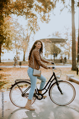 Young woman riding bicycle ...
