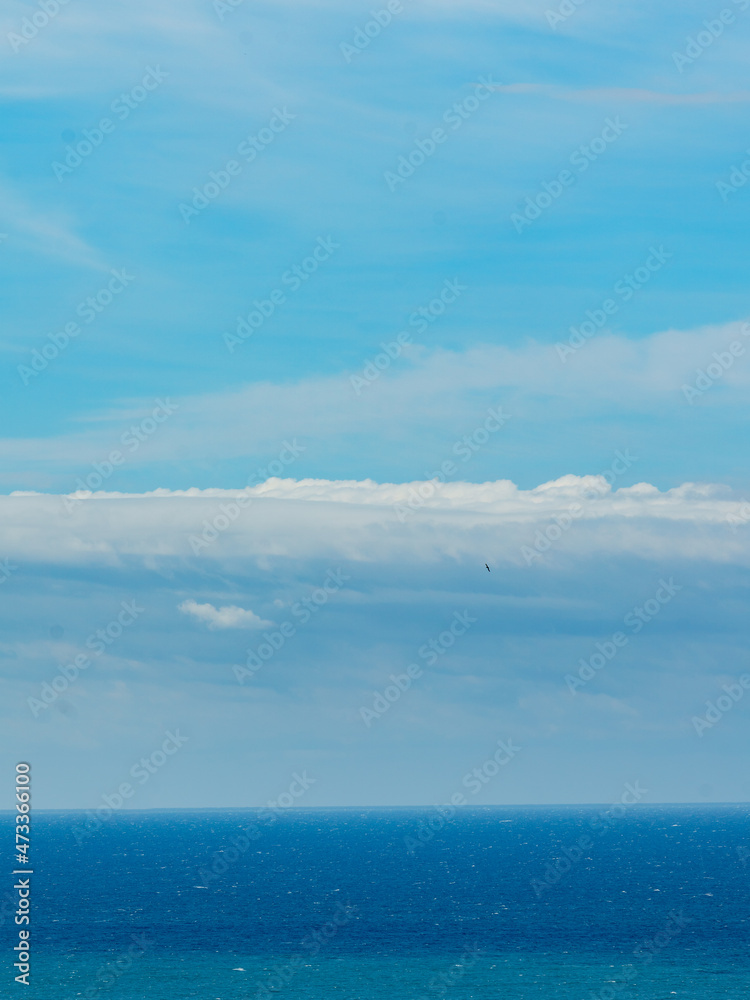 Fototapeta premium Panoramic view of bright blue sea, blue sky with fluffy white clouds