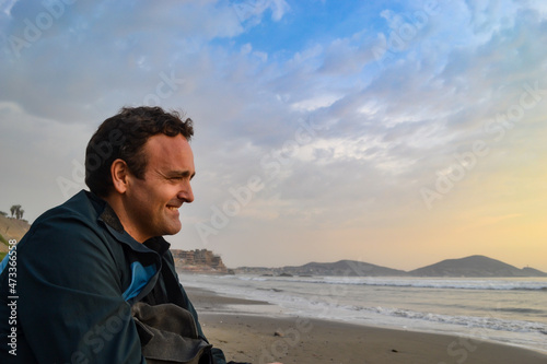 Cheerful mature Caucasian man looking at the sea.