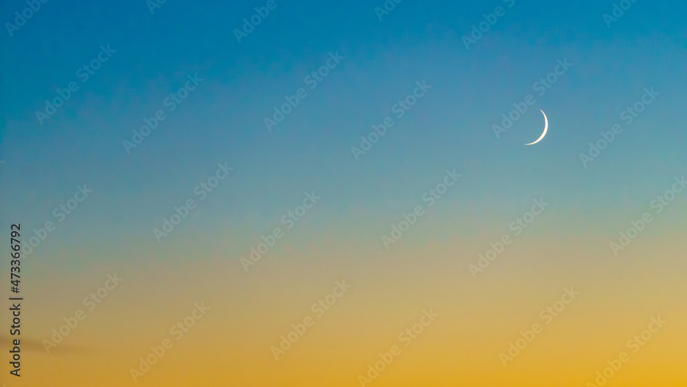 Crescent at the sunset sky. Sunset colors and new moon. Crescent at the sunset sky. Sunset colors and new moon.