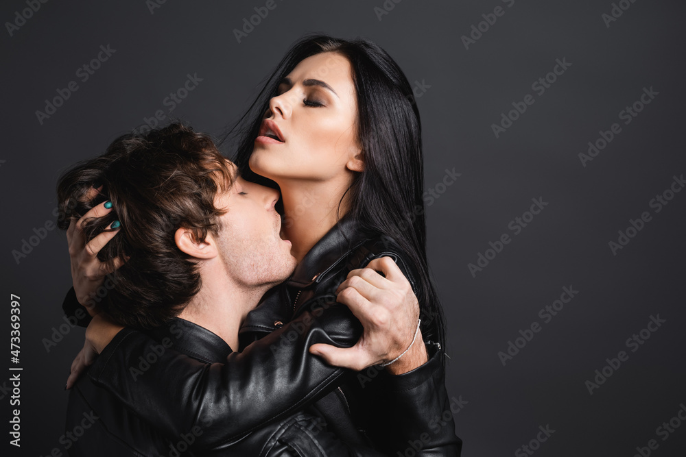 passionate man kissing neck of seductive woman isolated on grey. Stock  Photo | Adobe Stock