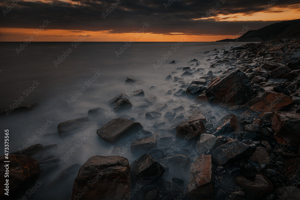 Dramatic sunset landscape with the rocky coast