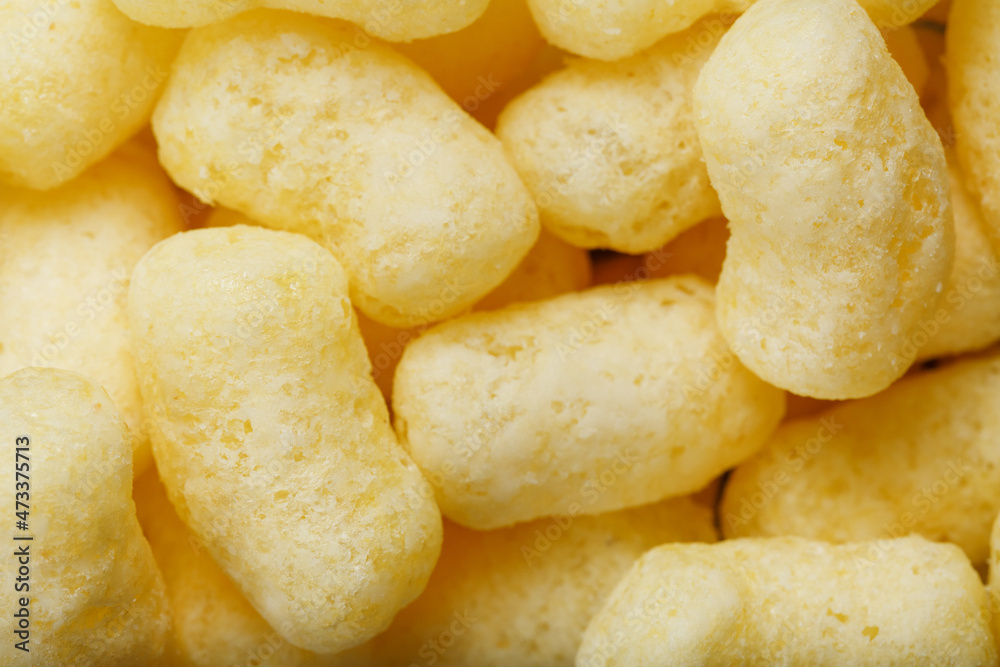 Golden corn sticks in powdered sugar close-up. Golden corn sticks in powdered sugar close-up.