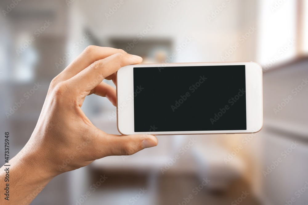 Hands hold smartphone with blank screen