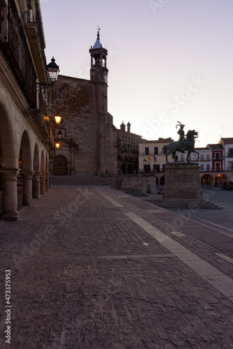 View of the main square of the medieval city of Trujillo with the Catholic Church of San Martin in gothic style and the equestrian statue of Francisco Pizarro at sunrise, Caceres, Extremadura, Spain © JMDuran Photography