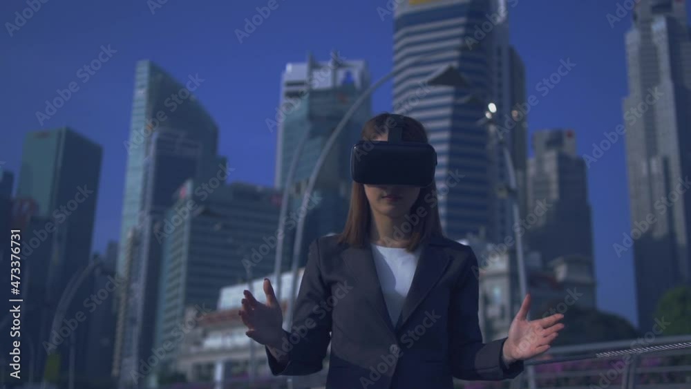Future is now. Woman using virtual reality device while traveling in Singapore . Future is now. Woman using virtual reality device while traveling in Singapore .
