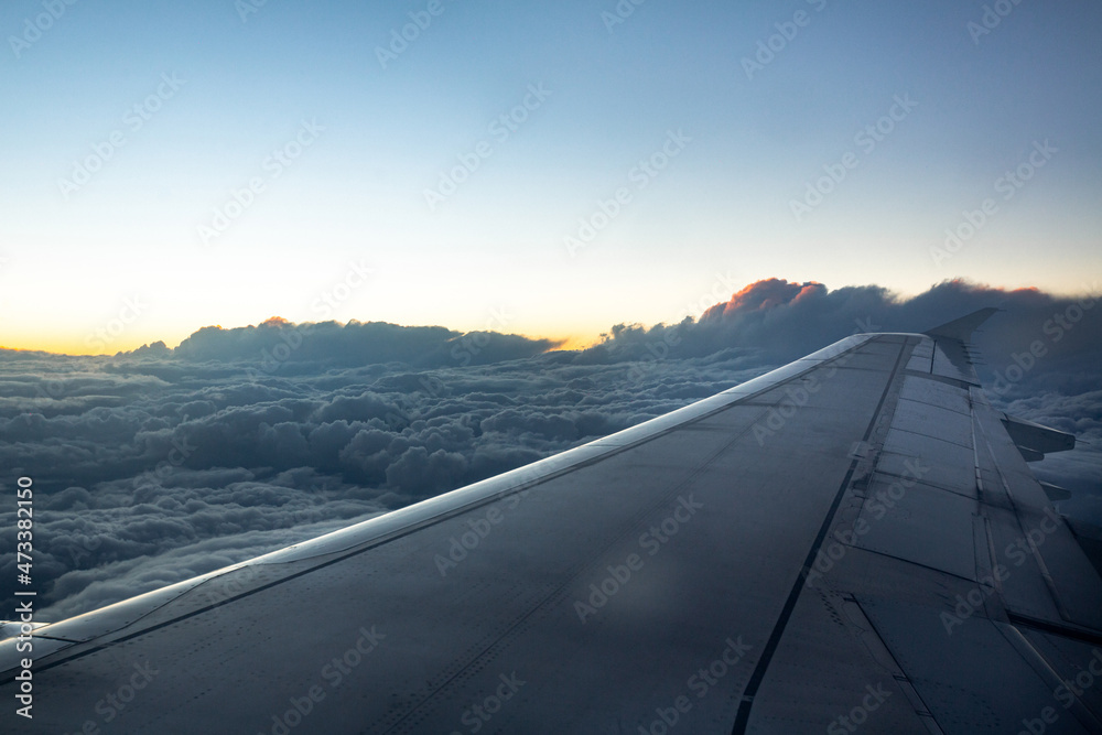 beautiful view of the plane wing, blue clouds and sunset beautiful view of the plane wing, blue clouds and sunset