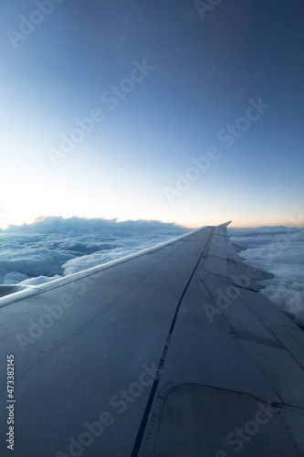 beautiful view of the plane wing, blue clouds and sunset © Nikita Shevchenko