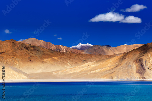 Mountains and Pangong tso Lake. Fluffy clouds and blue sky with Himalayan Mountain in the background, Leh, Ladakh, Jammu and Kashmir, India