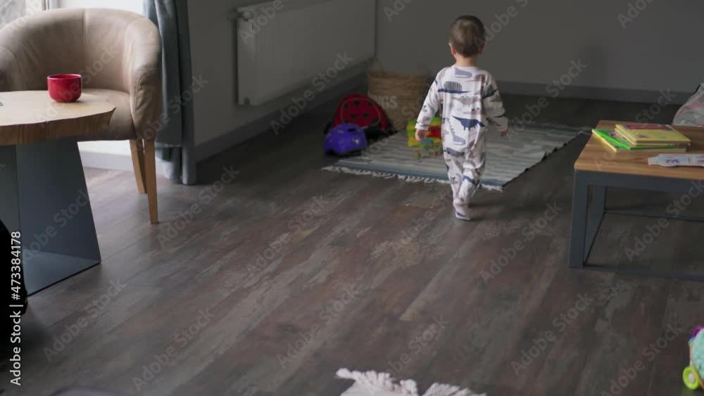 Back view of little child walking at home Back view of little child walking at home