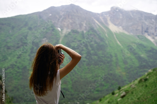 Woman photographer on nature landscape mountains travel