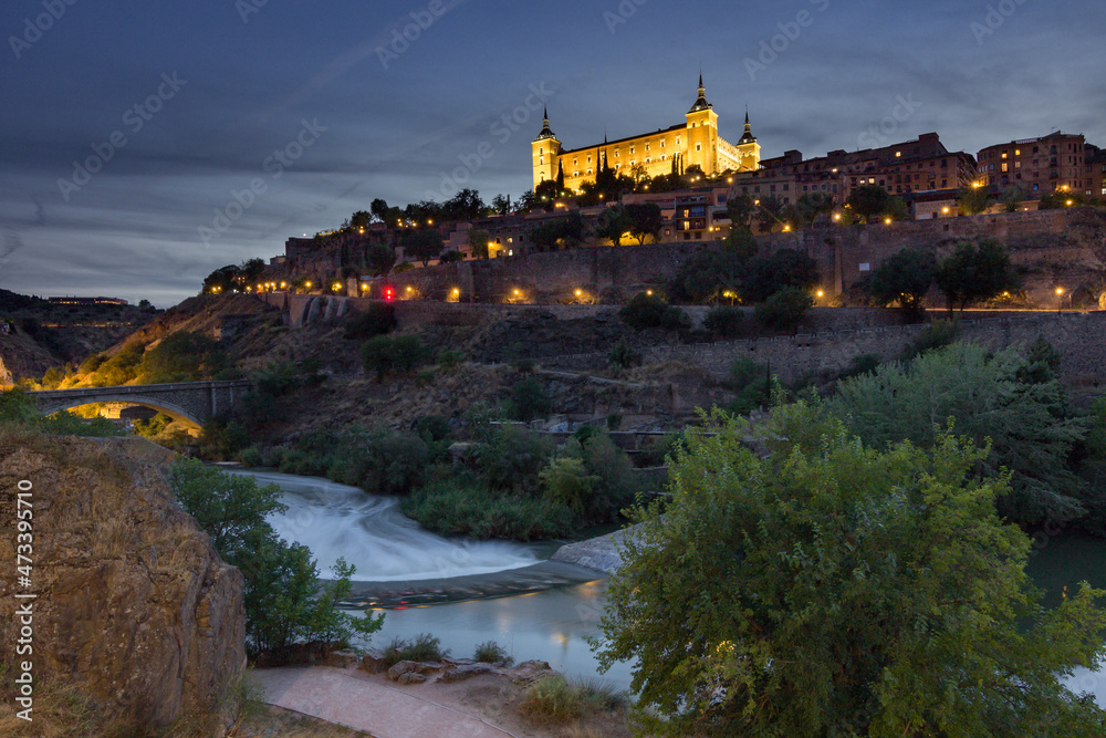 View of Alcantara bridge and the Alcazar of Toledo at night (Spain)