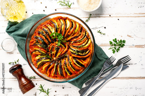 Obraz na płótnie Vegan dish ratatouille made of vegetables in a baking dish on wihte wooden rusti
