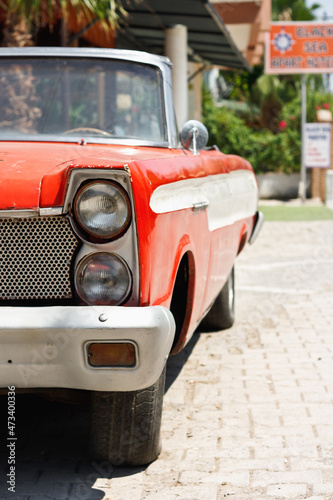 Old classic red car cabriolet in street. Retro automobile convertible concept photo