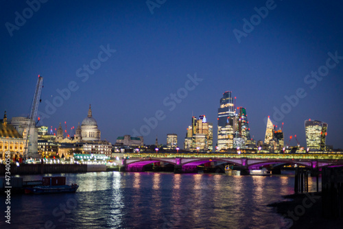 Blackfriars Bridge lit at night and St Pauls cathedral and Square Mile buildings, London, England, UK