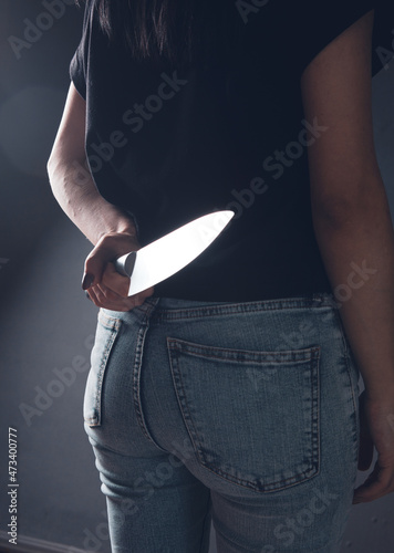 Fototapeta woman holding a knife from behind
