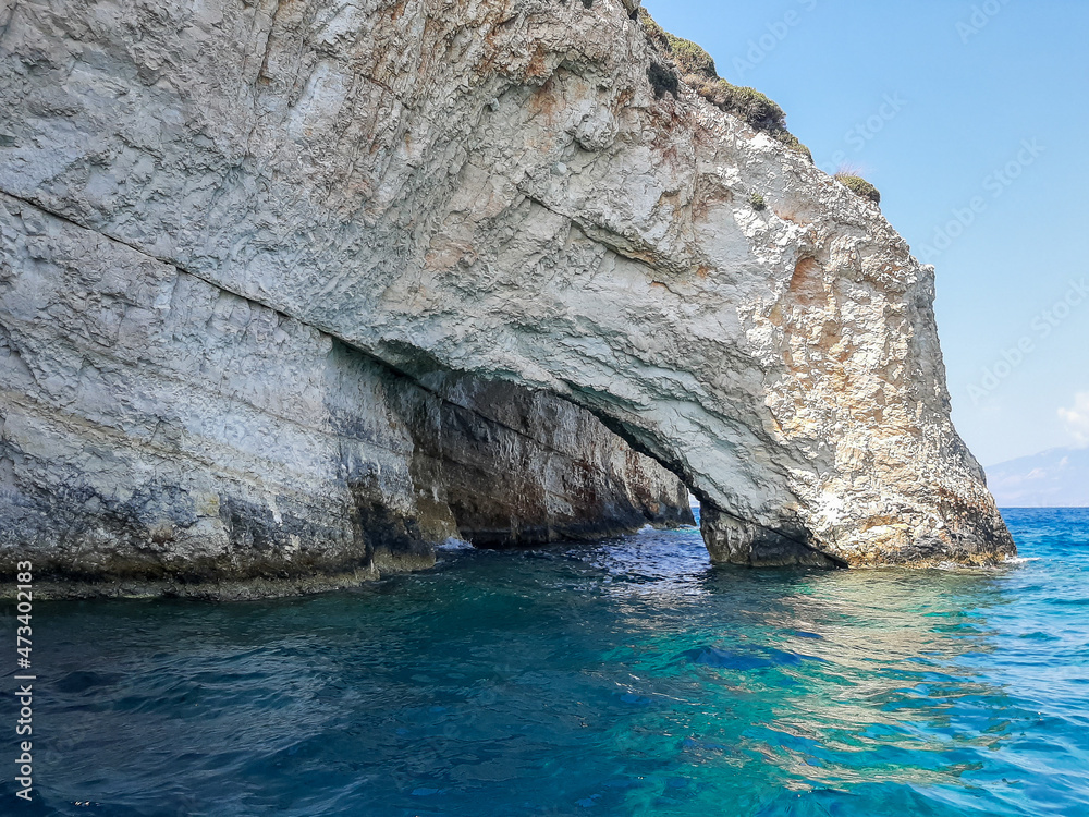 Hollow in the white limestone cliff, Zakynthos island, Greece