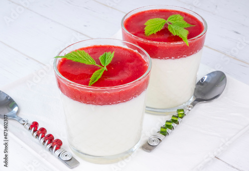 pana cotta in glasses with strawberry sauce on a white background photo