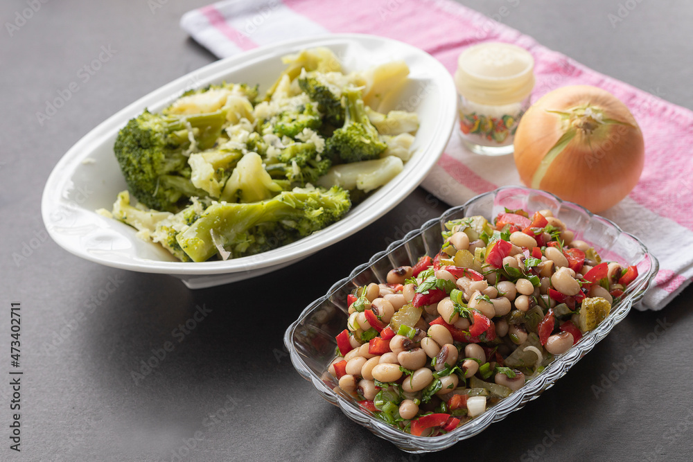 In the background broccoli salad in front Red pepper, pickled cucumbers, fresh onions Dried cowpea salad In the background broccoli salad in front Red pepper, pickled cucumbers, fresh onions Dried cowpea salad