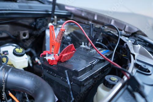 charging a dead car battery in winter, selective focus