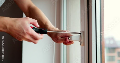 The worker installing and checking window in the house